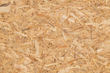 OSB tahta panel dokusu. Bastırılmış sarı turuncu kahverengi ahşap talaşı arka plan
