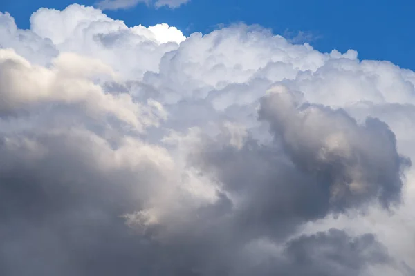 Storm sky. Big white cumulus clouds against blue sky background, cloud abstract texture, thunderstorm