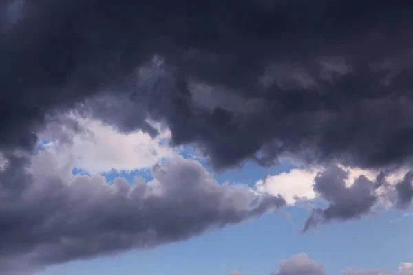 Epic dramatic Storm sky, dark grey and white cumulus clouds on blue sky background texture, thunderstorm