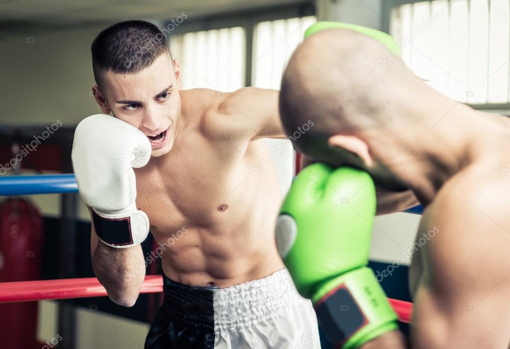 Kickboxers training on the ring 