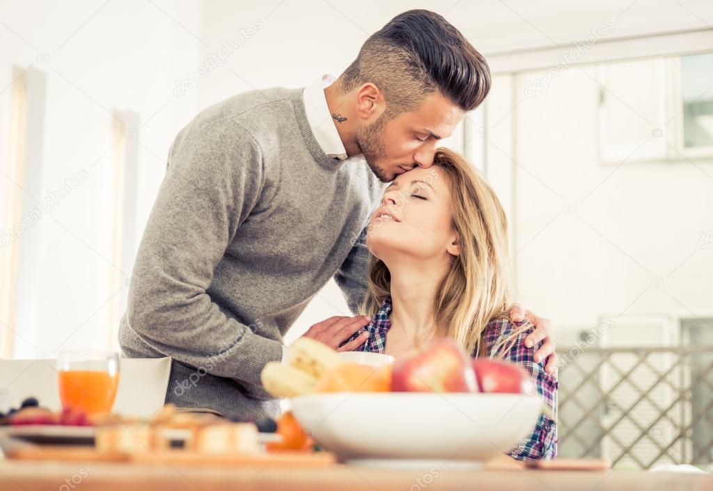 Young couple in love having breakfast at home.