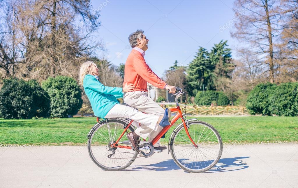 Senior couple riding bike