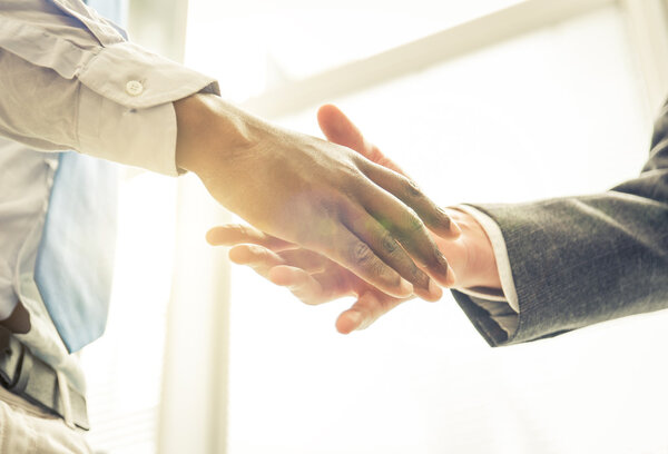 Business handshake. two men reaching an agreement