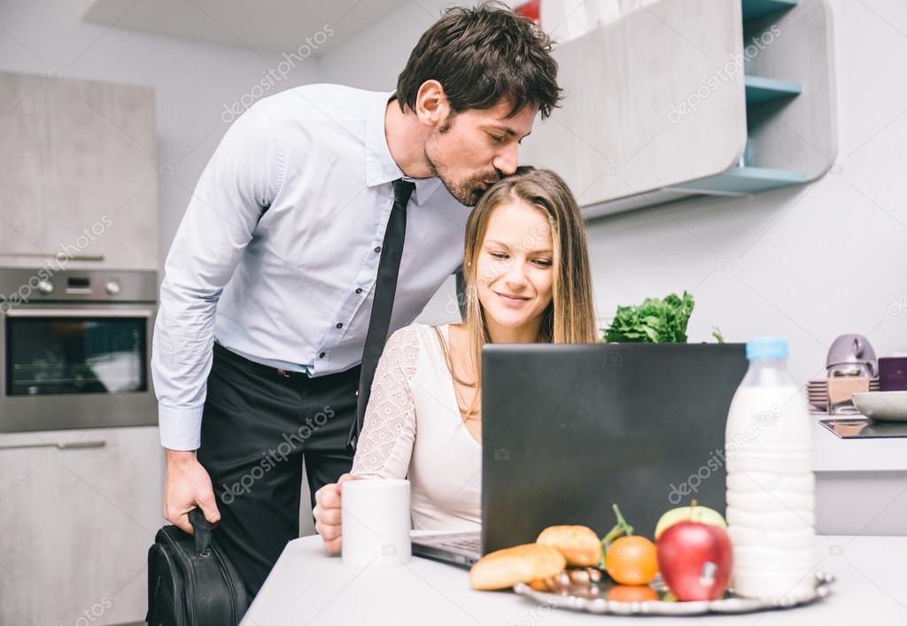 Husband kissing goodbye to his wife