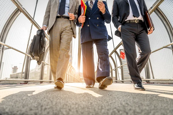 Businessmen walking outdoors — Stock Photo, Image
