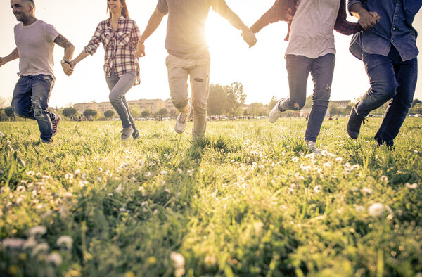 Group of friends running happily