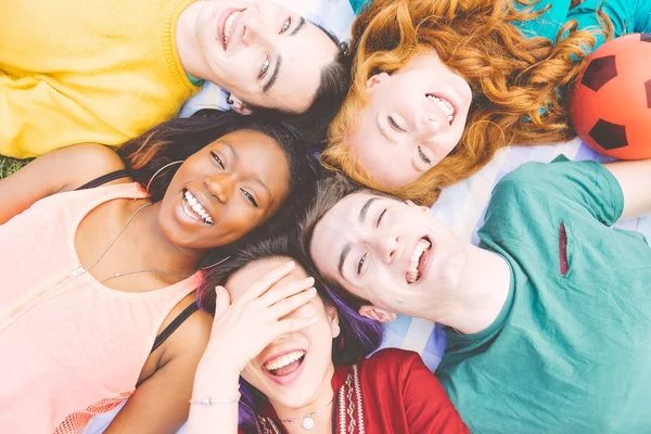 Group of four friends laughing out loud outdoor, sharing good an — Stock Photo, Image