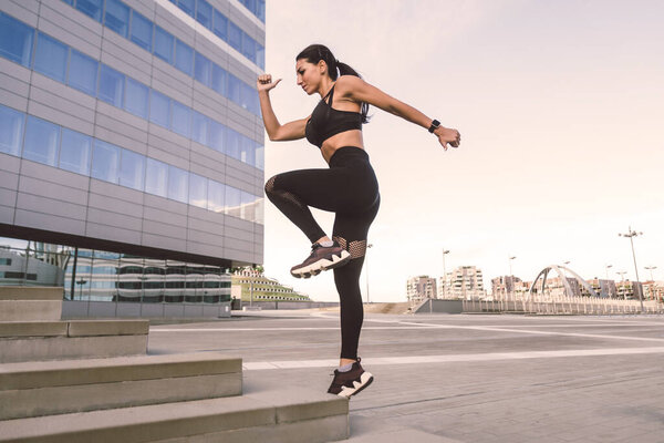 Sportive girl with fit body training outside - Beautiful woman doing some sport exercises, concepts about health, lifestyle and functional training