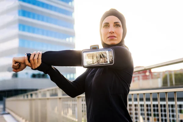 Muslim sportive girl with fit body training outside - Beautiful woman with hijab doing some sport exercises, concepts about health, lifestyle and functional training