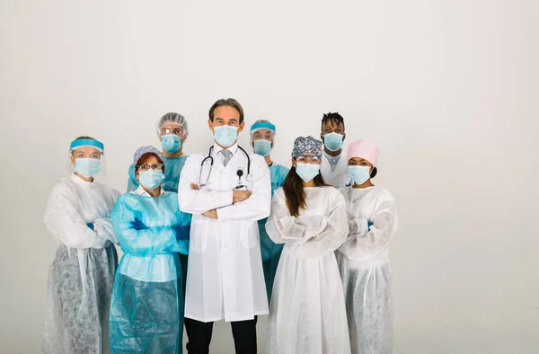 Team of doctors and nurses wearing disposable protection suits and face masks for fighting Covid-19 ( Corona virus ) - Medical team portrait during coronavirus pandemic quarantine, concepts about healthcare and medical