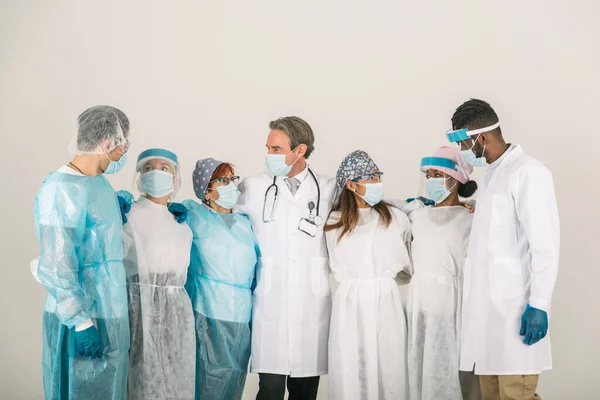 Team of doctors and nurses wearing disposable protection suits and face masks for fighting Covid-19 ( Corona virus ) - Medical team portrait during coronavirus pandemic quarantine, concepts about healthcare and medical