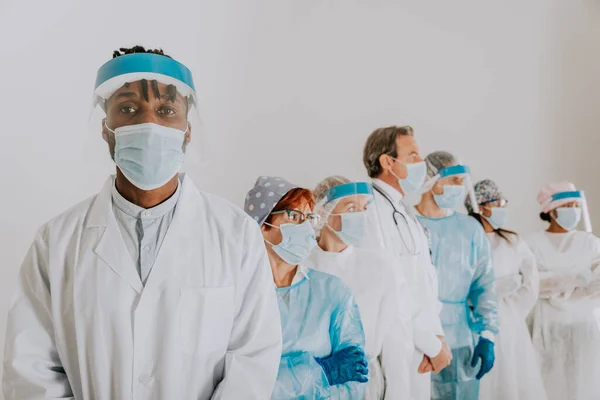 Team of doctors and nurses wearing disposable protection suits and face masks for fighting Covid-19 ( Corona virus ) - Medical team portrait during coronavirus pandemic quarantine, concepts about healthcare and medical
