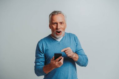 Yakışıklı son sınıf erkek portresi, arka planda stüdyo fotoğrafı, yaşlı bir adam, yarı vücut fotoğrafı.