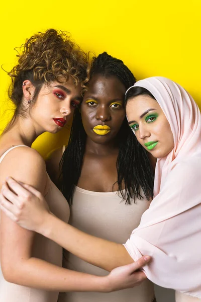 Multicultural group of beautiful women posing in underwear - 3 pretty girls portrait, concepts about multicultural people, inclusive society and body positivity
