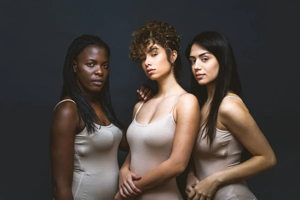 Multicultural group of beautiful women posing in underwear - 3 pretty girls portrait, concepts about multicultural people, inclusive society and body positivity