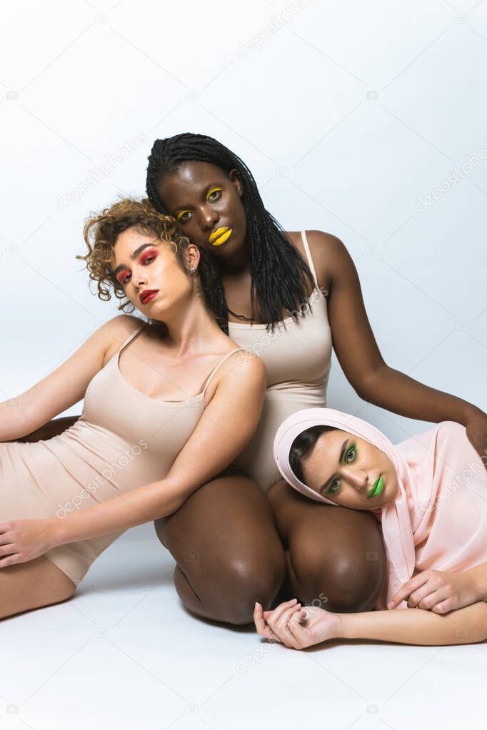 Multicultural group of beautiful women posing in underwear - 3 pretty girls portrait, concepts about multicultural people, inclusive society and body positivity