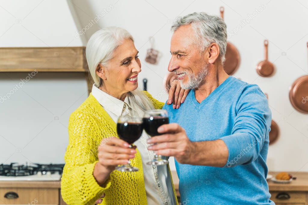 Beautiful senior couple of lovers  - Elderly people portrait while having fun at home - Concepts about relationship, elderly people and lifestyle