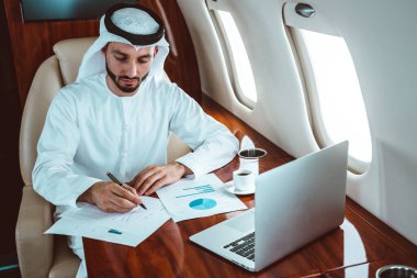 Business man from united arab emirates flying on his private jet to Dubai clipart