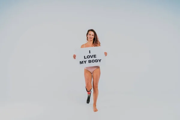 Beautiful young woman with amputation - Pretty and confident woman with leg disability, amputee posing against body shaming