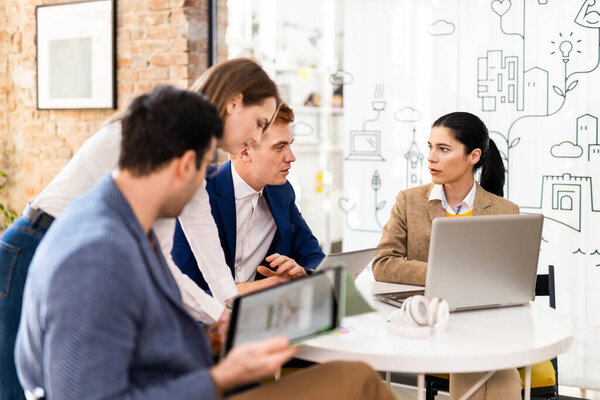 Project managers and employees brainstorming on ideas - Multi-ethnic group of workers having business meeting in a start-up office