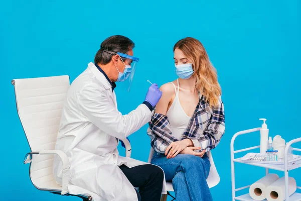 Covid-19 ( coronavirus) vaccination campaign in a clinic - People getting vaccinated from doctor and nurse to prevent corona virus outbreak in a vaccination point