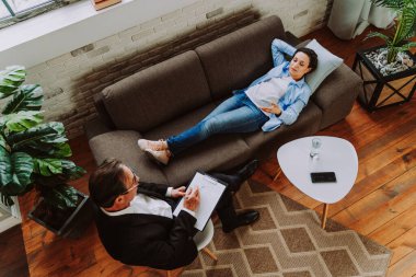 Depresyon ve ilişki sorunları olan bir kadın - Psikoterapist stüdyosu, hasta ile seans yapan bir psikolog