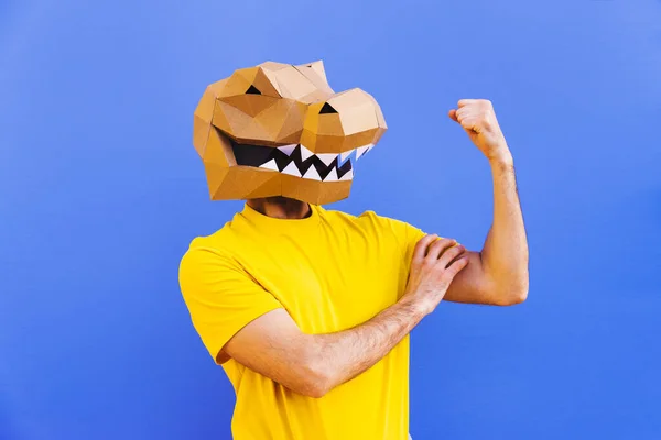 Cool man wearing 3d origami mask with stylish colored clothes - Creative concept for advertising, animal head mask doing funny things on colorful background