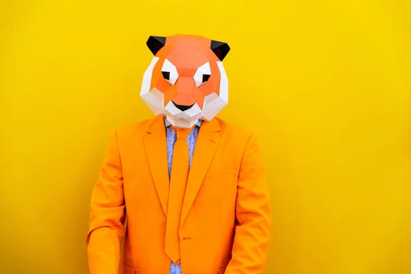 Cool man wearing 3d origami mask with stylish colored clothes - Creative concept for advertising, animal head mask doing funny things on colorful background