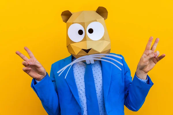 Cool man wearing 3d origami mask with stylish colored clothes - Creative concept for advertising, animal head mask doing funny things on colorful background