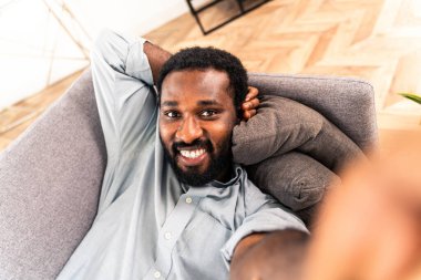 Evde yakışıklı siyah bir adam var.