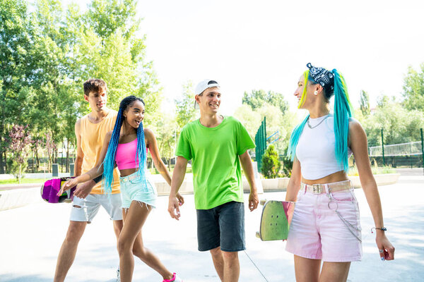 Group of skaters teens at the skatepark. Professional skateboarders having fun together