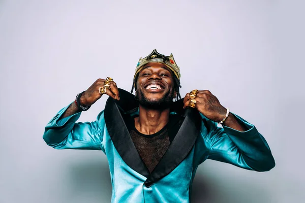 portrait of an hip hop music musician. Cinematic image of a man wearing party clothes and jewels