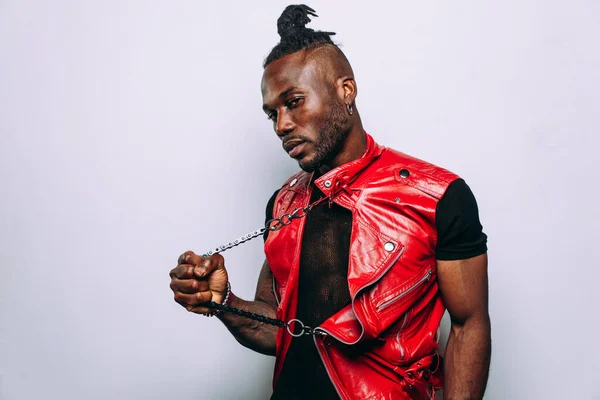 handsome man wearing red leather jacket portrait. Futuristic cyberpunk fashion style. Studio light shot on white background