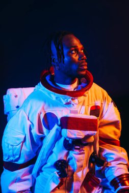 Bir astronotun sinematik görüntüsü. Uzay elbisesi olan bir adamın renkli portresi.