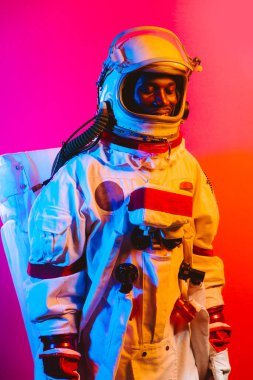 Bir astronotun sinematik görüntüsü. Uzay elbisesi olan bir adamın renkli portresi.
