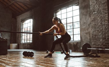 Güzel bir kadın antrenmanı ve spor salonunda egzersiz yapıyor.