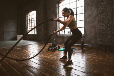 Güzel bir kadın antrenmanı ve spor salonunda egzersiz yapıyor.