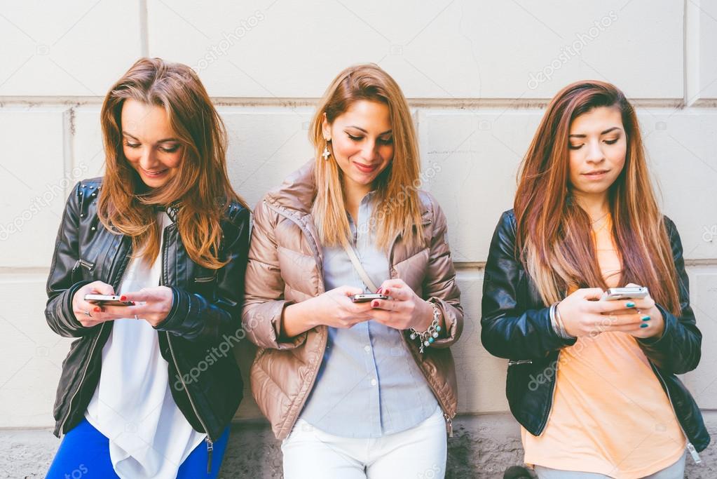 Women typing on mobile phones