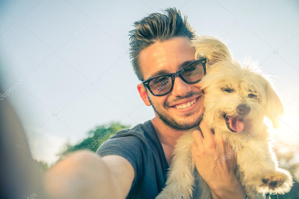 Young man and his dog taking a selfie