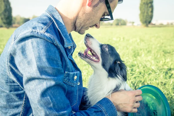 Cool dog playing with his owner — Stock Photo, Image
