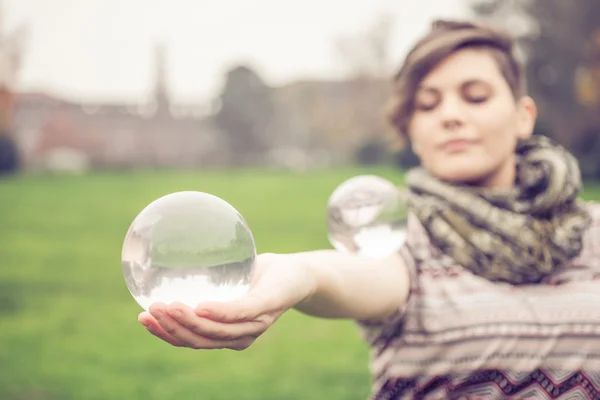 Woman balancing crystal ball — Stock Photo, Image