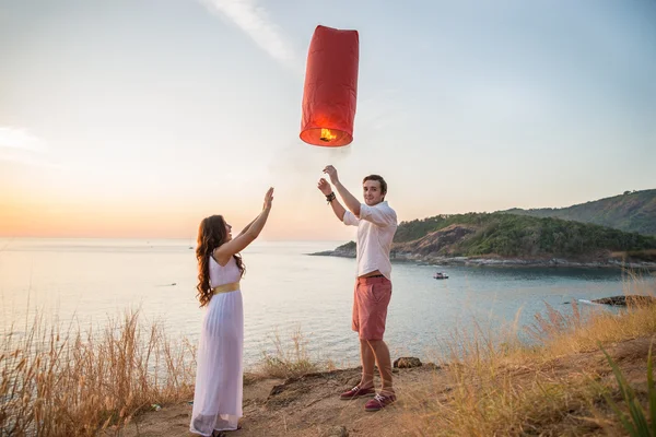 Romantic couple holding fire lanter — Stock Photo, Image