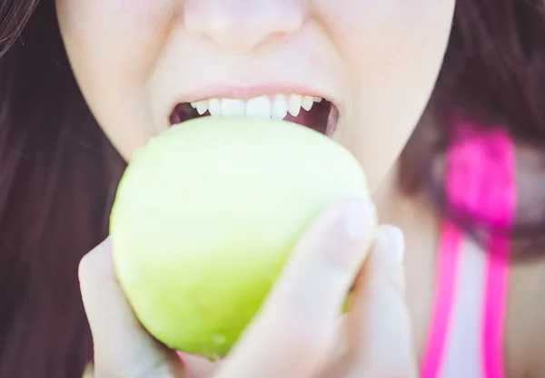 Mujer mordiendo manzana verde —  Fotos de Stock