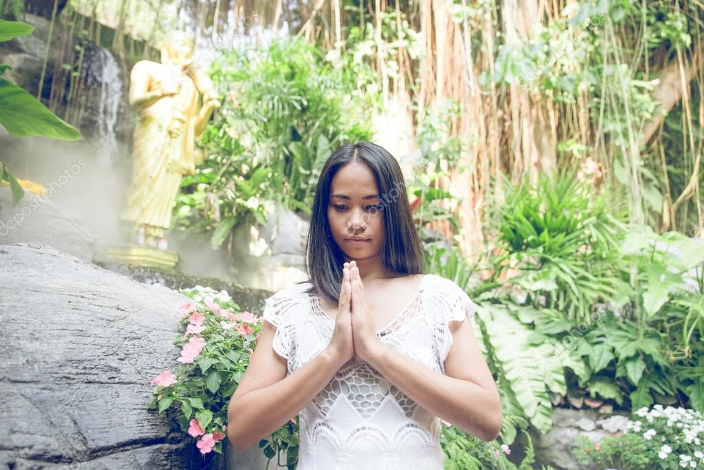 thai woman praying in a buddhist  temple