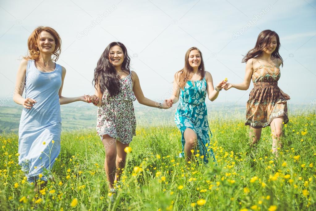 four girls running in the fields