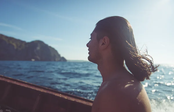 Hombre con pelo en el viento en el barco —  Fotos de Stock