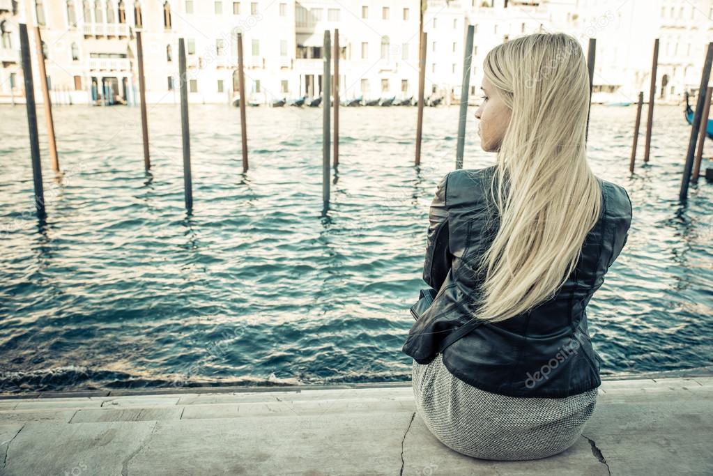 blonde girl sitting in Venice
