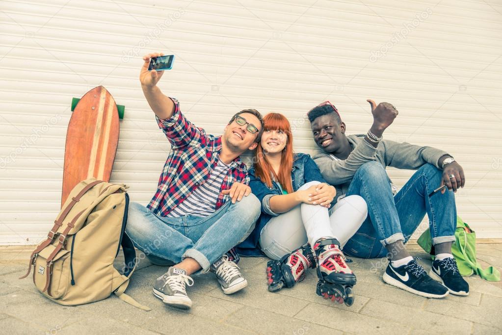 Multiracial group taking selfie