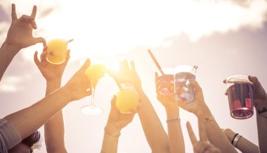 hands up to the sky with cocktails