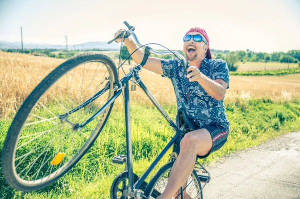Senior man on bike — Stock Photo, Image